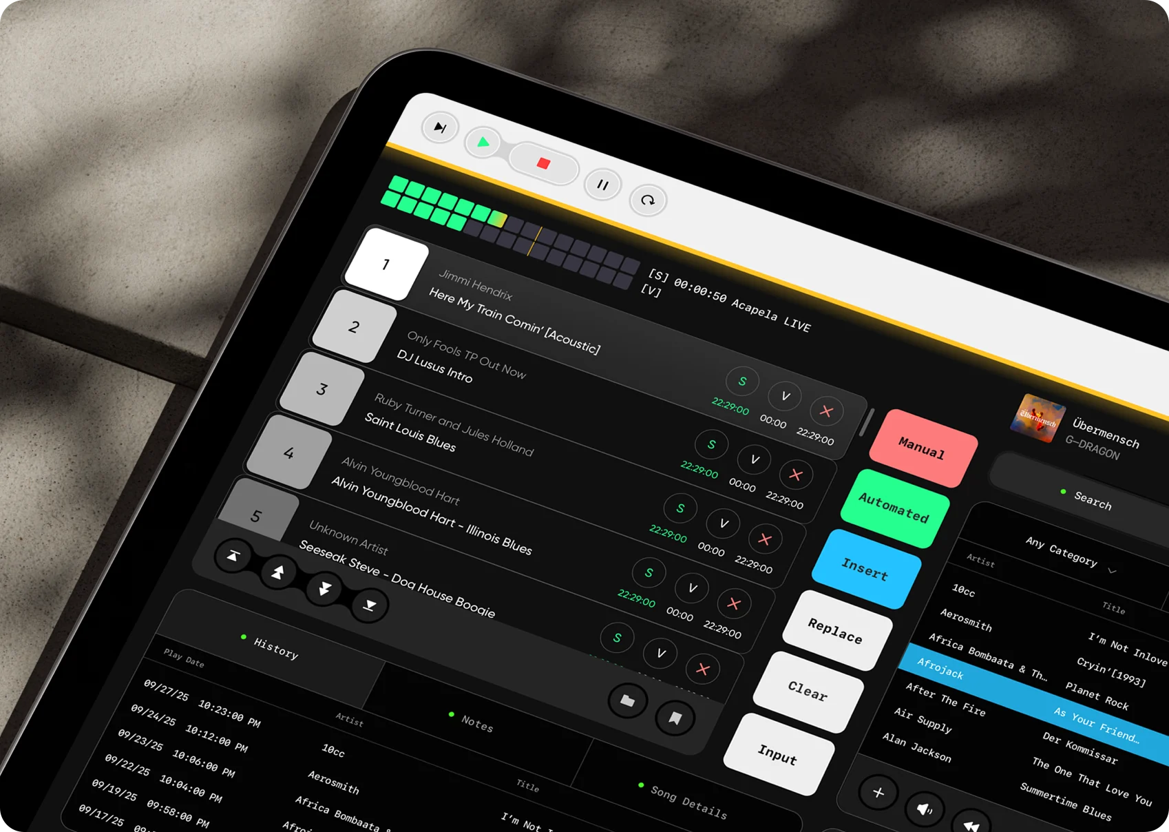 Tablet on a desk in the studio showing the redesigned Radio DJ interface: track queue, mode buttons and library